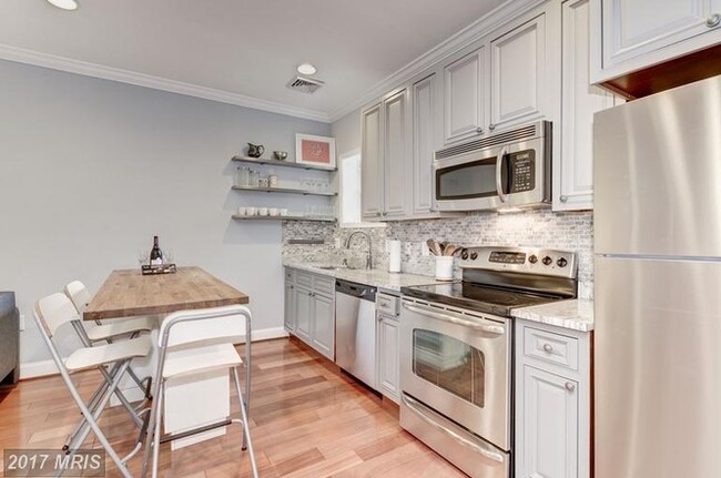 Kitchen with movable storage island - 52 New York Ave NW