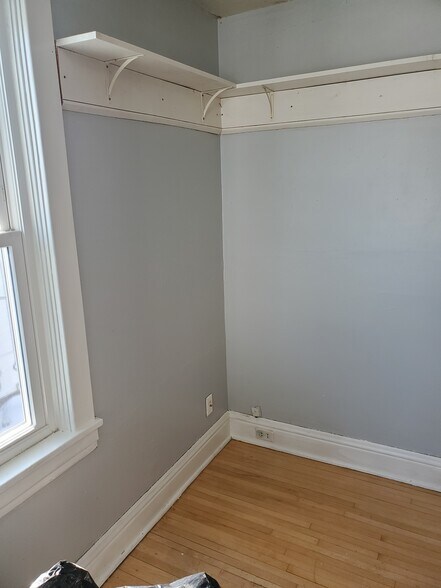 studio room with light grey walls - 606 7th St N