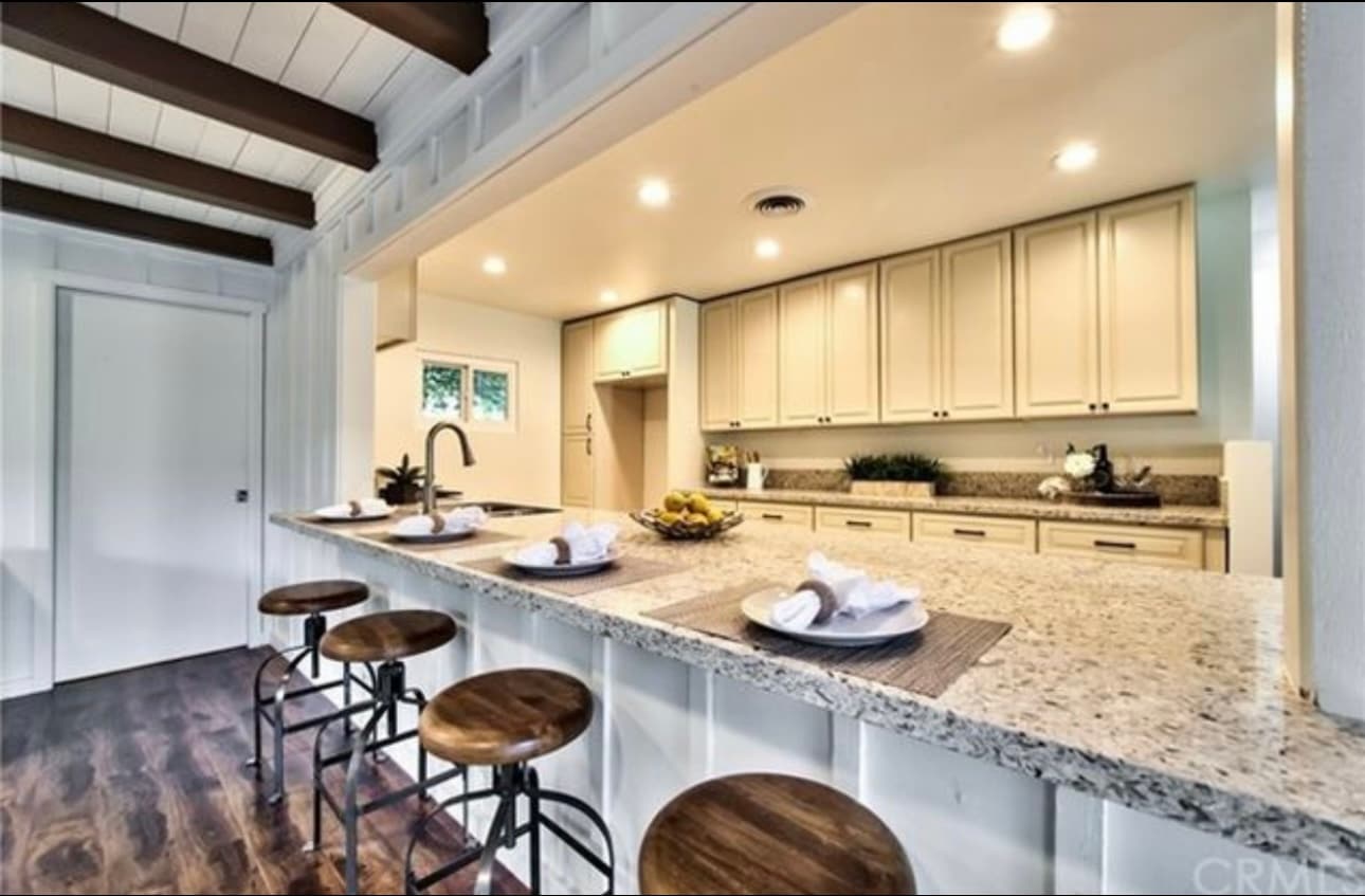 Spacious kitchen with granite counters, ample cabinetry, and breakfast bar - 332 E Deodar St