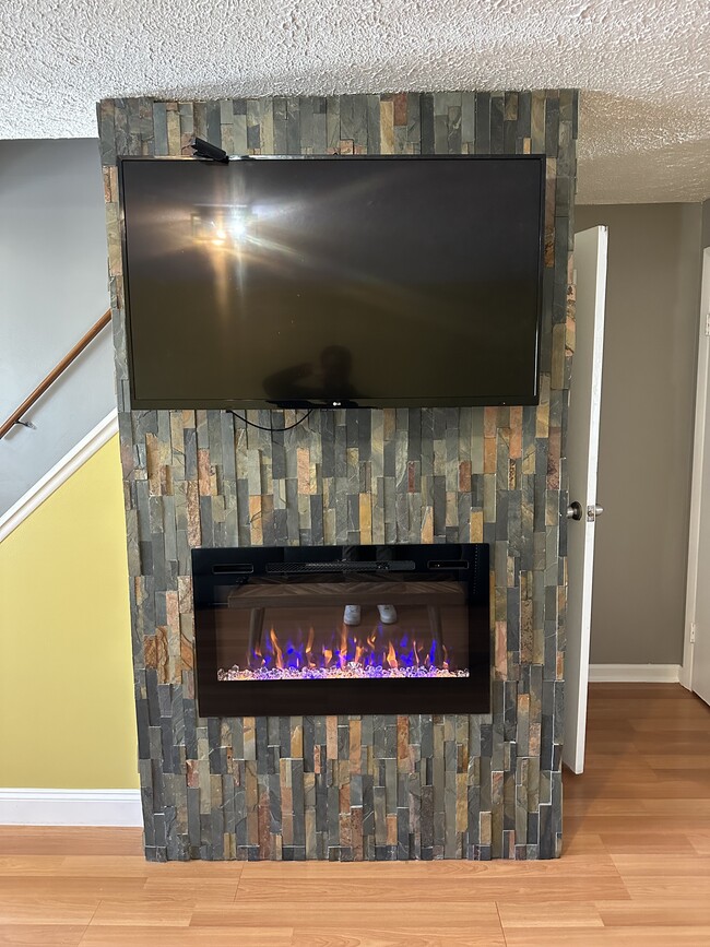 Electric fireplace with slate stone surround - 1082H Mount Hope Ave