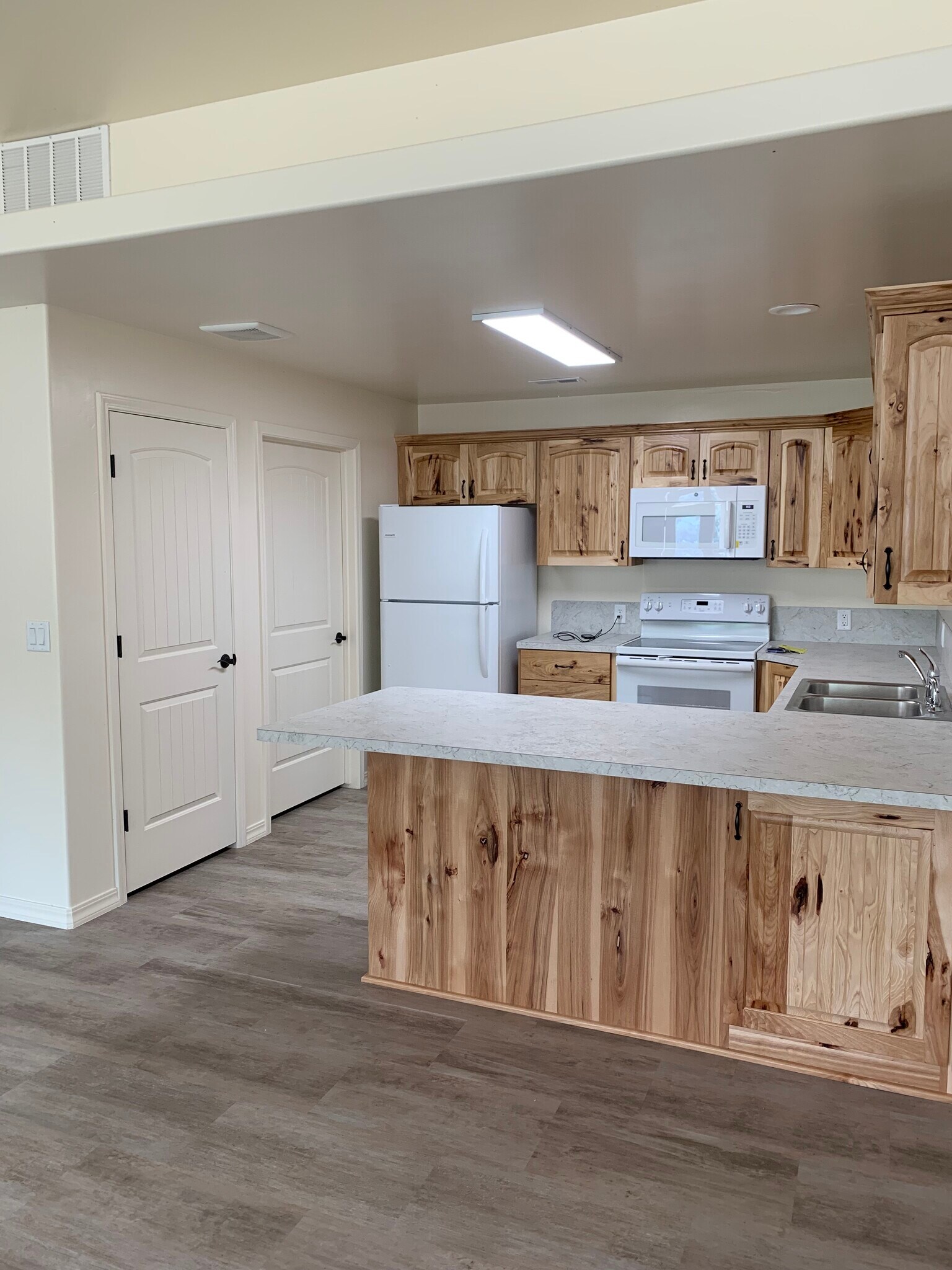 Kitchen w/ pantry door & utility room door - 2100 E Olympic Ave
