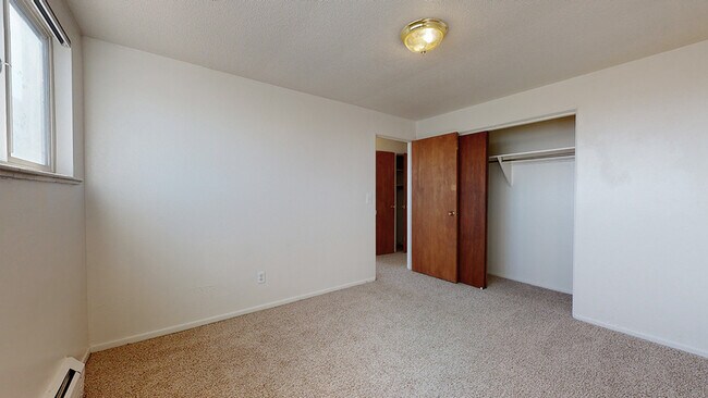 A bright and inviting bedroom ready for your personal touch. - Harmony Apartments