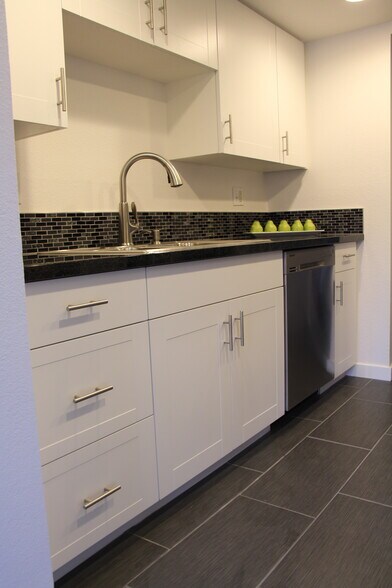 The kitchen features tile flooring and dishwasher - 10418 Northeast 32nd Place