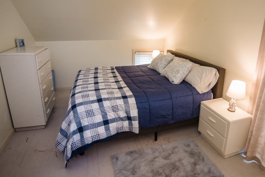 MBR with king bed with Avocado mattress, en-suite full bath, and walk-out balcony with a view! - 5277 Main St