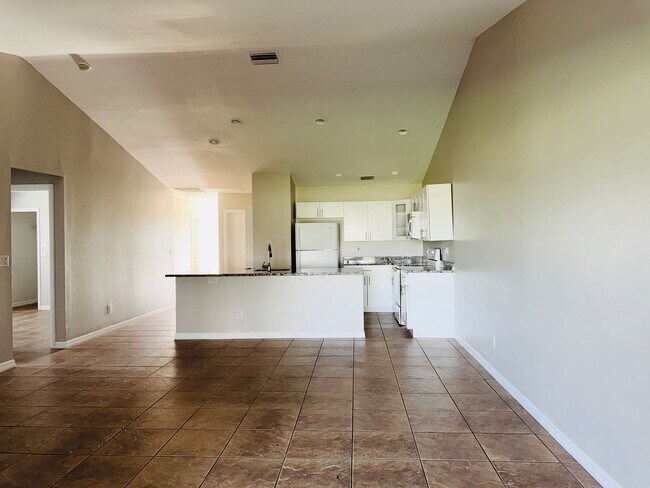 Building Photo - Experience this Cape Coral 3 bedroom 2 bath corner duplex with 1 car garage and screened in lanai.