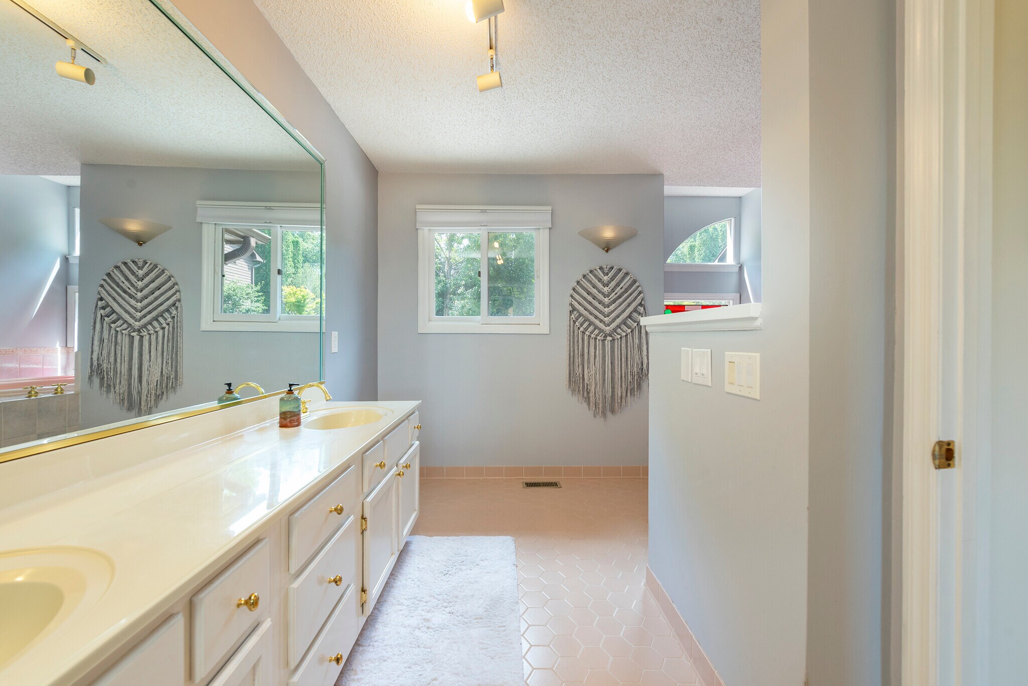 Spa-inspired master bath featuring an oversized double vanity, custom lighting, and finishes. - 405 Windswept Dr