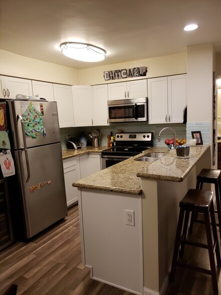 Newly installed flooring and green glass tile backsplash. New cabinets. - 1775 Diamond St