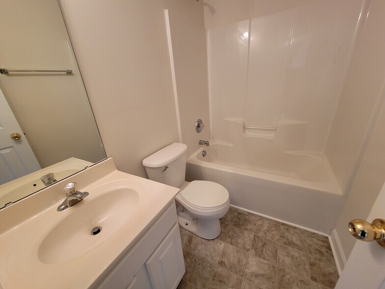 The main upstairs bathroom is at the end of the hall. - 6903 Seney Dr