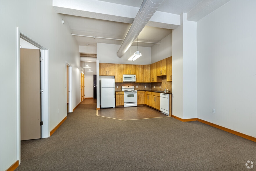 2BR, 1BA - 910SF - Living Room and Kitchen - Grand Boulevard Lofts