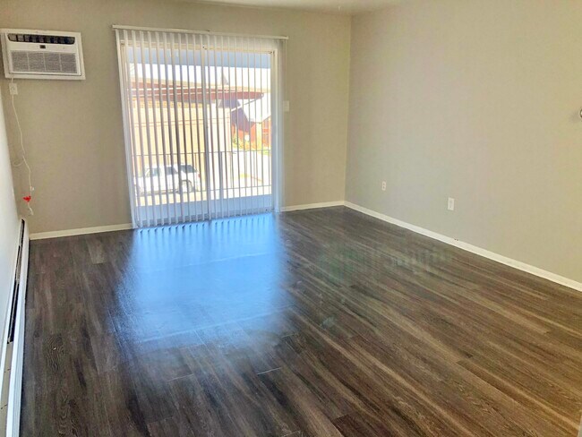 Explore this bright and inviting living room, perfect for relaxation and entertainment. - GRACE LANDINGS APARTMENTS