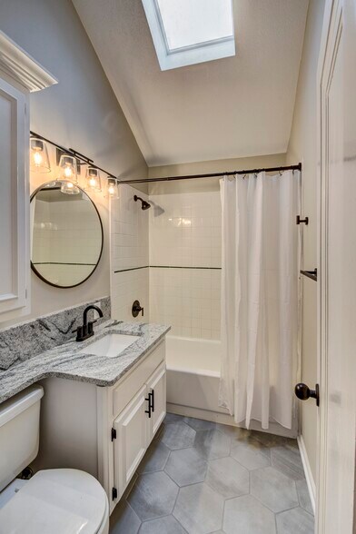 New hexagon tile floor, faucets, sink, quart countertop, hardware, lights, and mirror. - 5210 Rees St