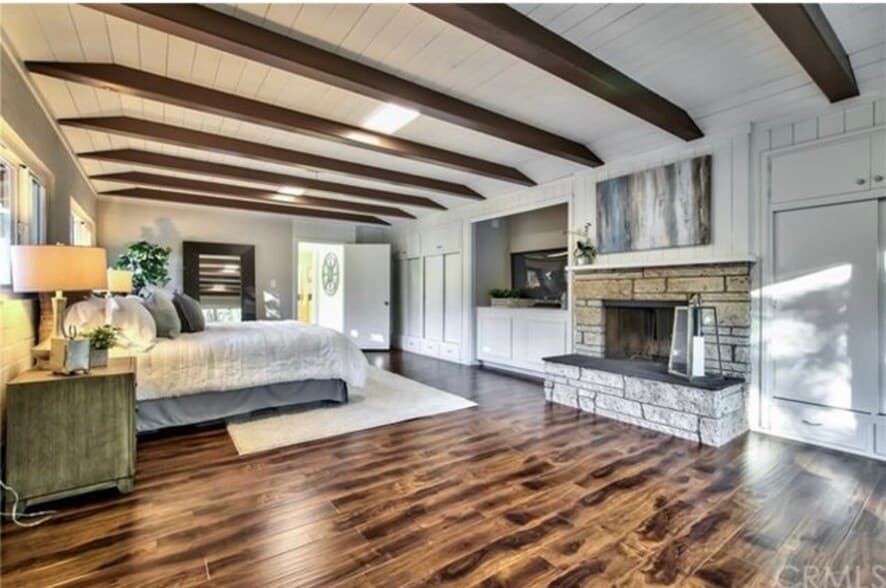 Spacious master with beamed ceilings, fireplace, wall of windows, patio access & 3 closets. - 332 E Deodar St