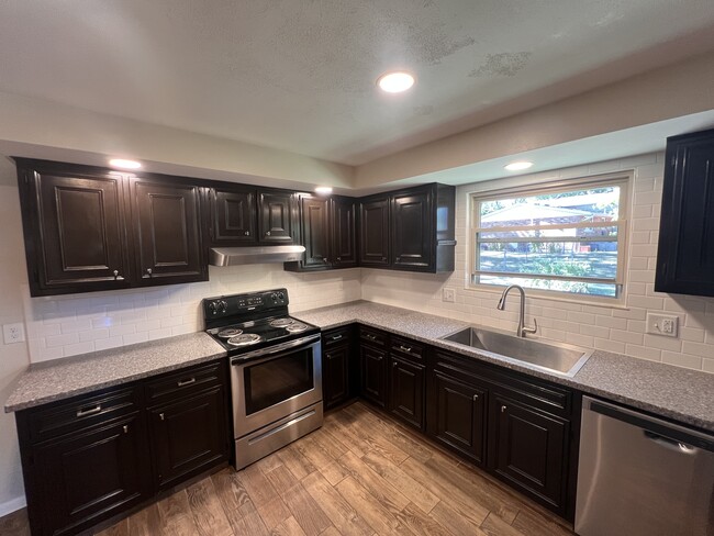 Electric stove with range hood. - 1298 Cedarcliff Dr