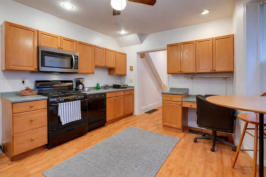 AI visualization of kitchen with new stainless microwave & brass hardware (install in progress) - 513 1/2 W James St