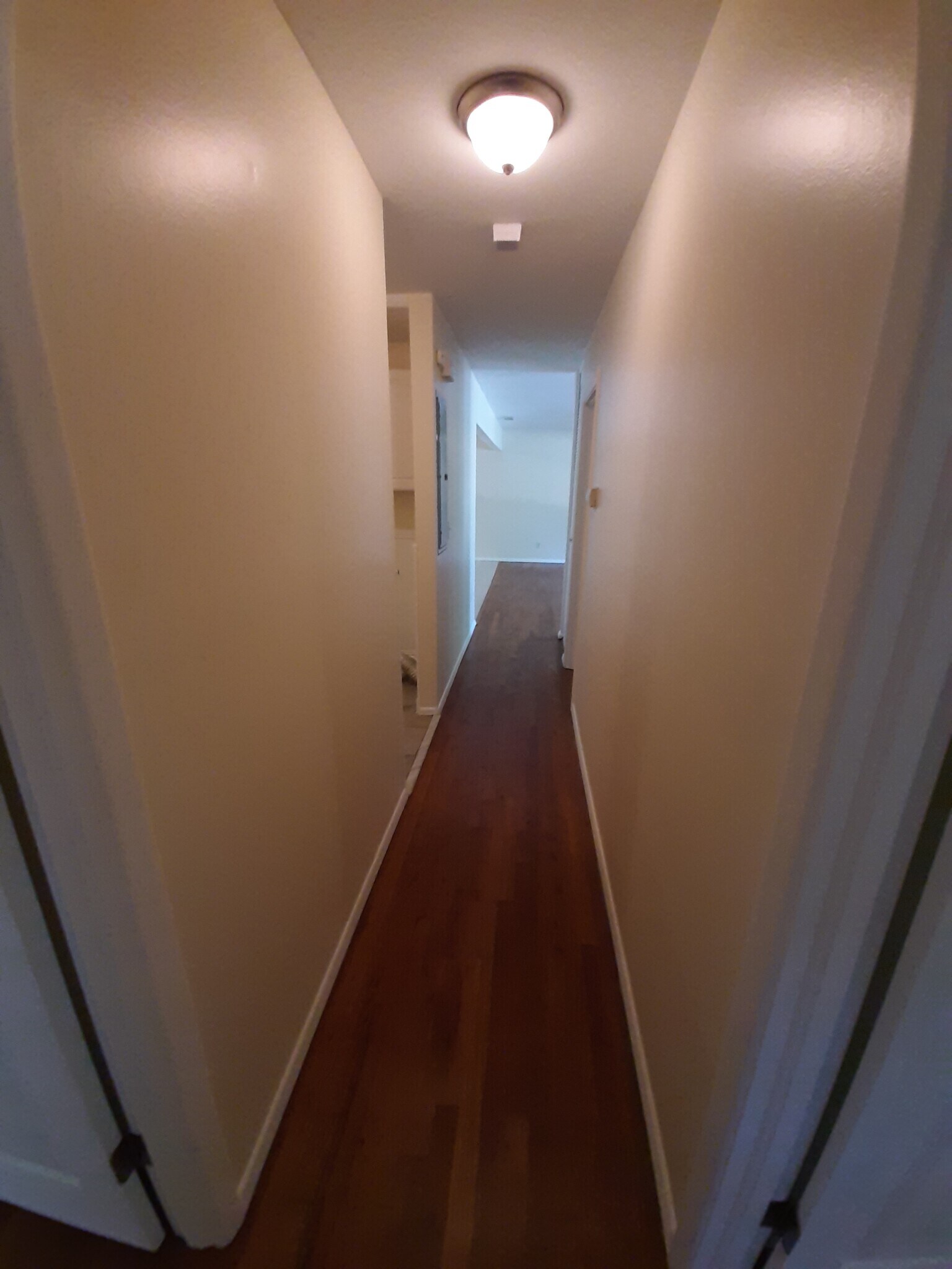 The hallway takes you back to the open living space. - 2955 Fantasy Ln