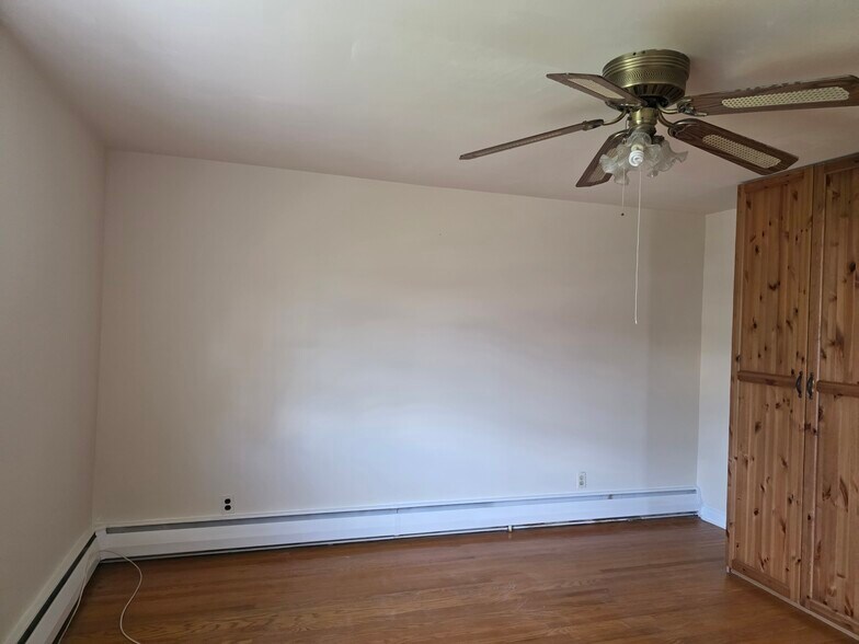 Main bedroom with walk in closet and a large wooden shelf - 20 W Marthart Ave