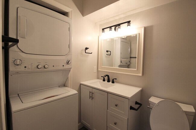 Building Photo - Fun and Stylish Living at Madison Manor! Top-Floor Condo with Vaulted Ceilings and Skylights