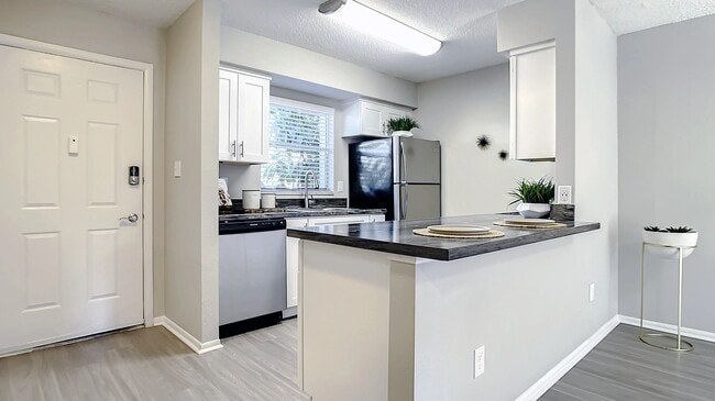 Select floor plans feature kitchens with spacious, open breakfast bars - a host's dream for gatherings and good times. - Slate Luxury Apartments
