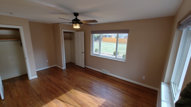 Bedroom 1 with 2 closets, 2 windows and ceiling fan - 6934 Winding Way