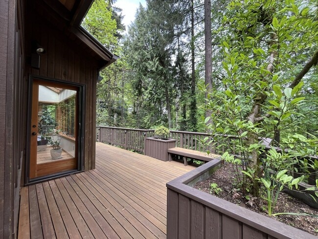 Building Photo - One-of-a-Kind Custom Home with Wall of Windows, Stone Fireplaces, Expansive Entertainment Space &...