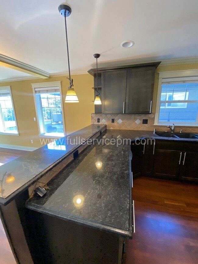 Building Photo - Spacious townhome with private backyard, garage parking, multiple decks, and a dedicated home off...