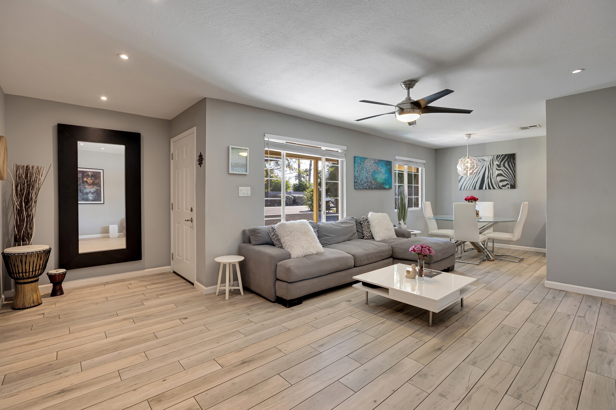 Bright, spacious living room with contemporary finishes and porcelain tile flooring - 6136 N 9th St