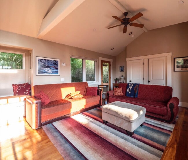 Living space with view of patio and hot tub in bamboo garden - 132 Anthony St