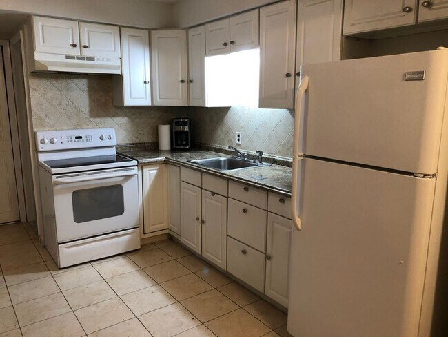 Full stack kitchen with coffee maker, stove, oven, microwave, full size fridge and pots & pans. - 8315 Karam Blvd