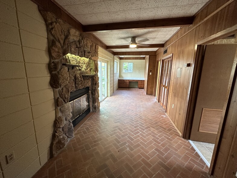 Great room with fireplace and work station, brick flooring - 353 E Airport Ave