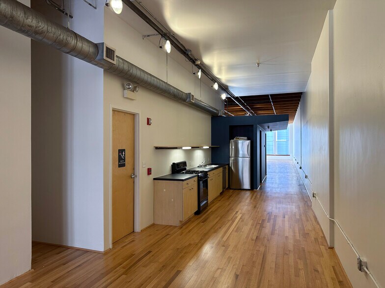 View of kitchen from elevator landing - 945 Liberty Ave