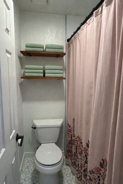 Well-designed bathroom featuring a separate water closet for added privacy. - 524 Superior St