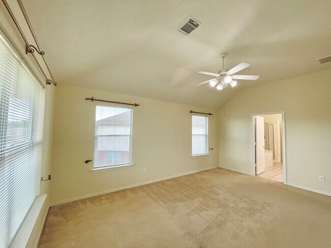 Primary bedroom on 2nd floor with plenty of natural lighting and connected bath and walk-in closet. - 18911 Piney Bend Ct