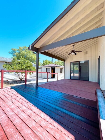 Enjoy year-round comfort on this stylish covered patio with ceiling fan and ambient lighting. - 4570 58th St