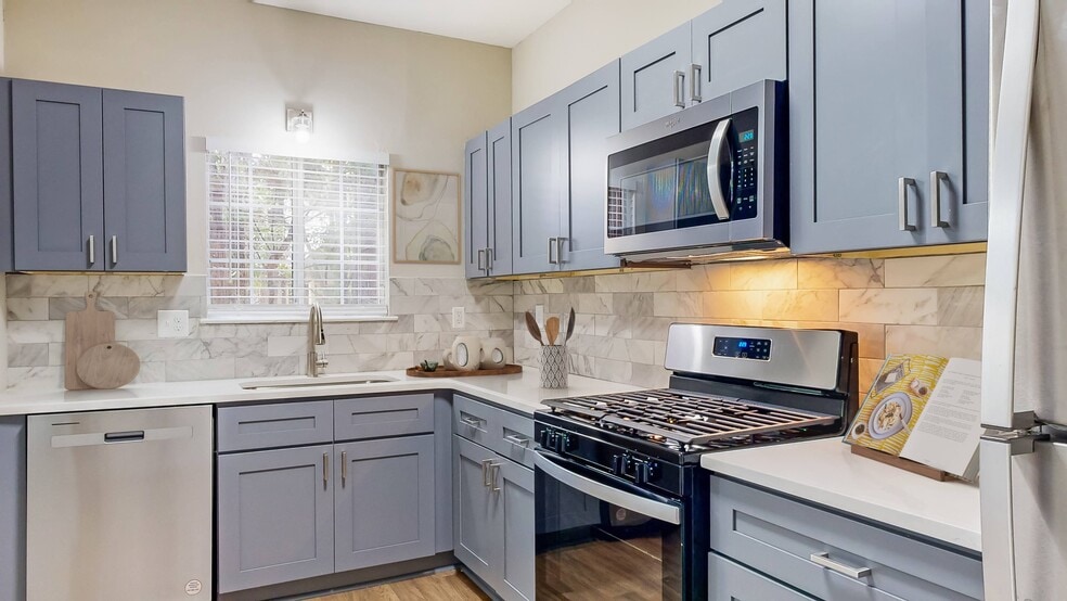 Kitchen with Stainless Steel Appliances and Quartz Countertops - Creekside at White Oak