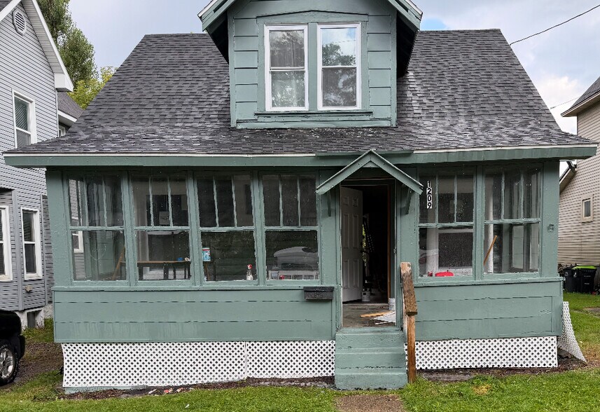 Enclosed porch front and deck in back - 1209 Tweed St