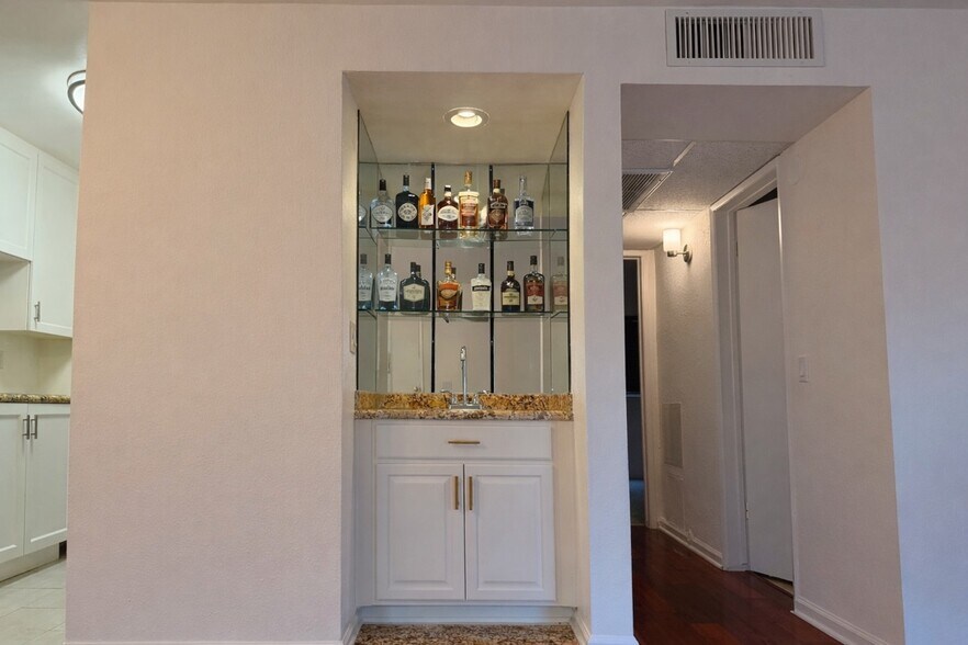 Built-in wet bar with mirrored glass shelving and granite counter — a WeHo entertainer's dream - 970 Palm Avenue