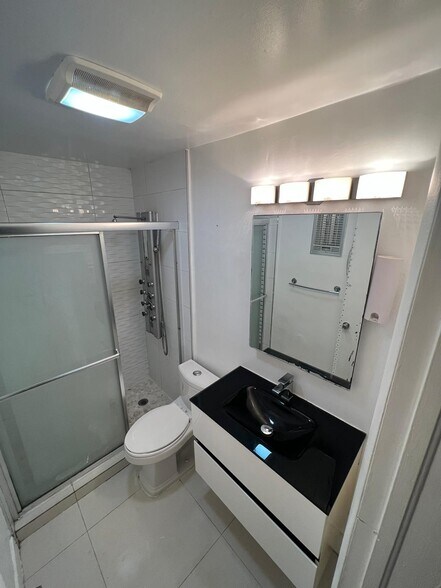 Spa-inspired private bathroom with shower panel - 1560 NE 127th St