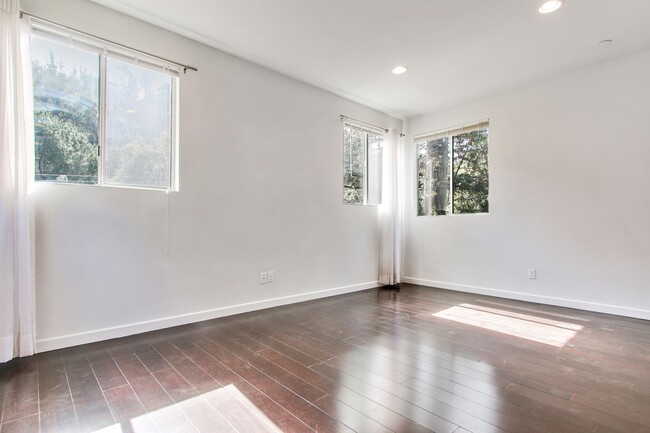 one view of the master bedroom it has many windows to enoy the view of the canyon . - 8725 Lookout Mountain Ave