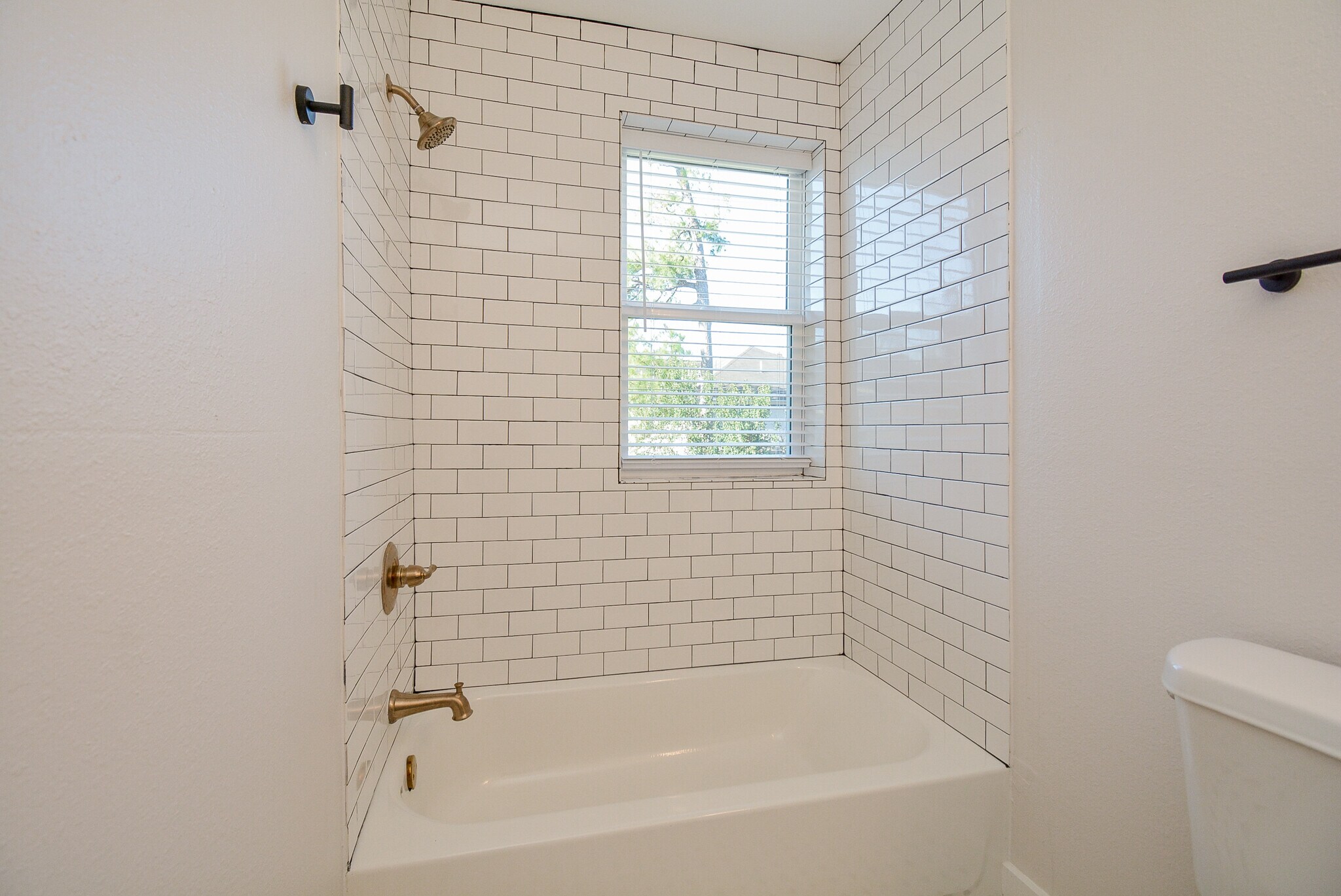 Private bath for Bedroom 3 with natural light and brushed gold fixtures - 2916 Arbor St
