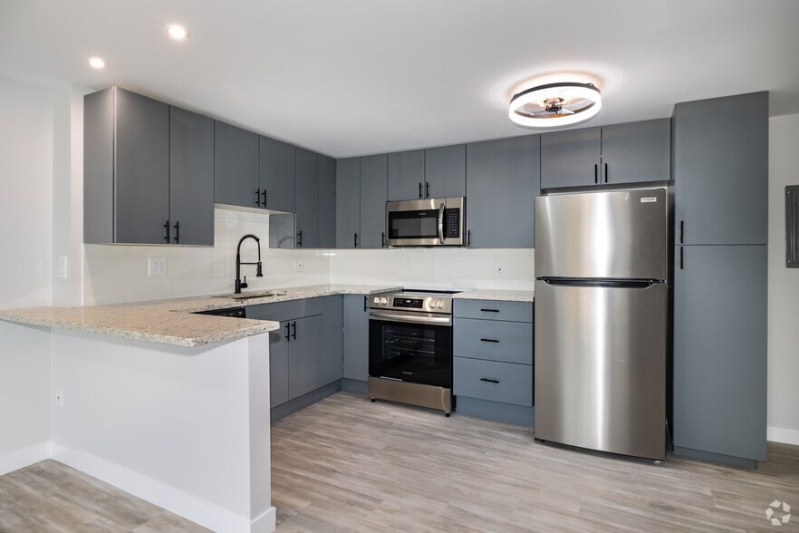 2BR, 2BA - 975SF - East Grey/Black - Kitchen - Arvada Court Apartments - Utilities included!