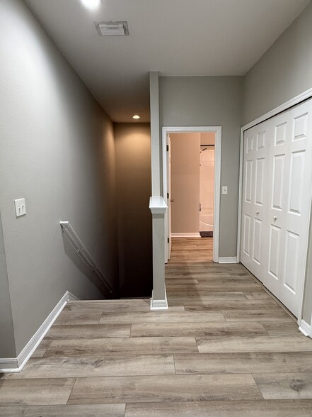 Hallway to laundry, 2nd bathroom + stairs to garage - 9410 Georgian Park Ln