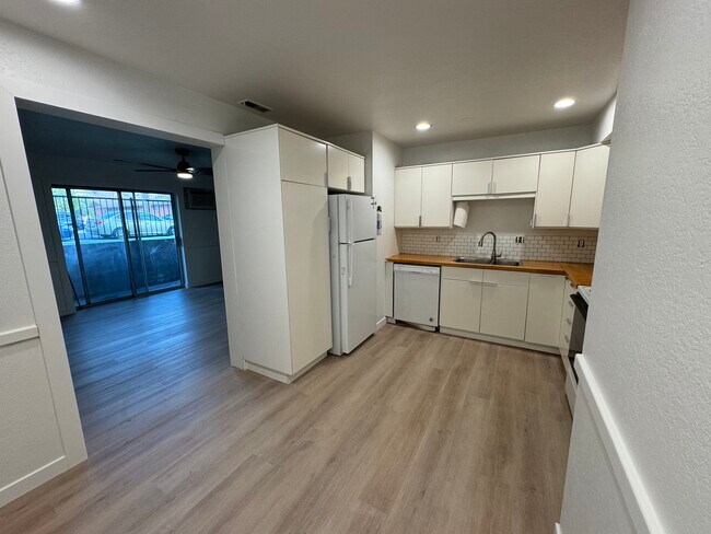 Bright open kitchen with tile backsplash and butcher block counter - 387 N 200 E