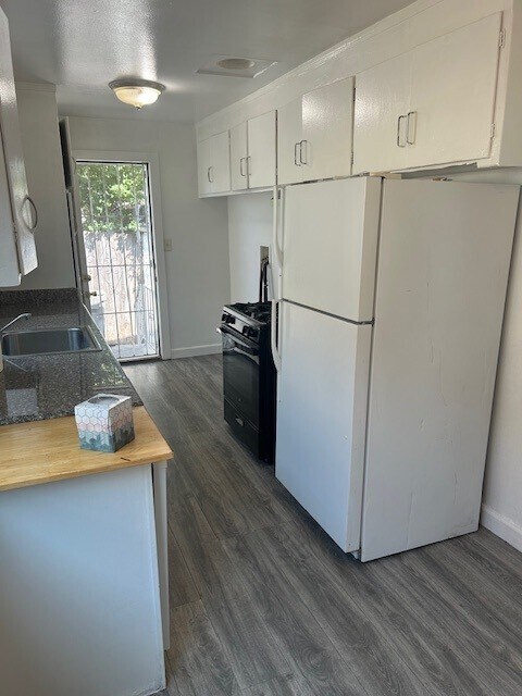 White refrigerator just replaced with a brand new black one - 2639 38th Ave