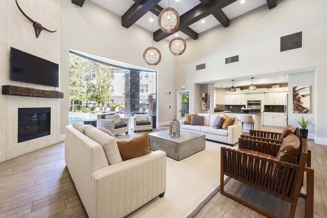 Settle into the lounge and enjoy a comfortable space to relax, work, or connect with neighbors. - The Estates at Cougar Mountain
