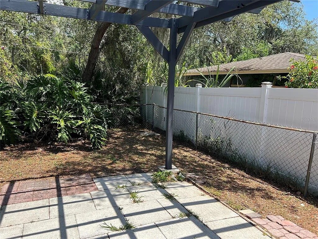 Patio with freshly painted pergola off screen room - 261 Deleon Rd