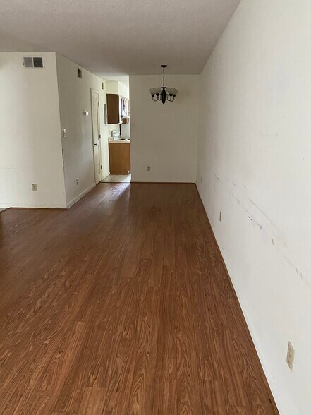 Living area with hardwood floors. Has been repainted after photos - 1412 11th St S