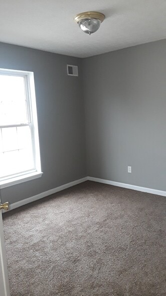 Bedroom #2 with new paint and carpet - 1216 Lipps Ln