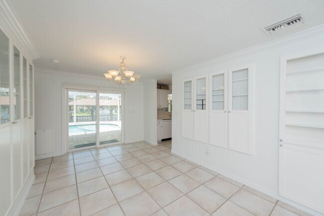 Building Photo - Live the ultimate Space Coast waterfront lifestyle at this stunning beachside canal home in Satel...