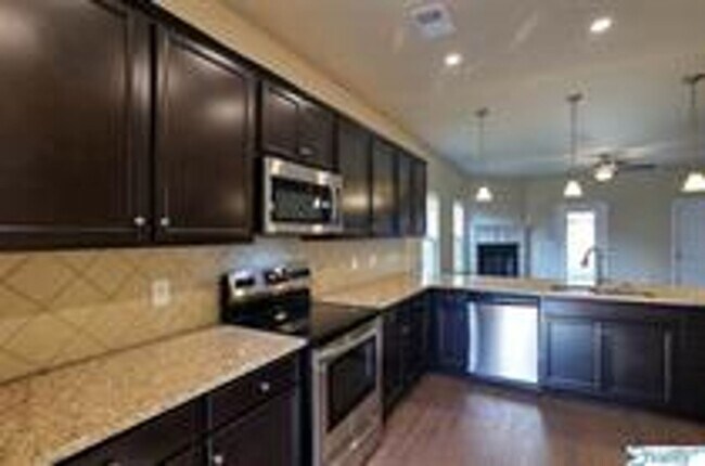 Building Photo - COMING SOON! Welcome to the Carlyle—where classic brick farmhouse charm meets a sleek, modern lif...