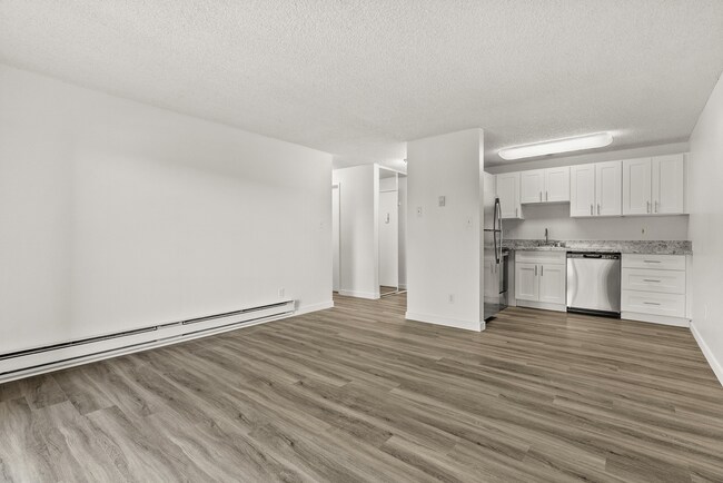 Enjoy open-concept living with modern finishes, spacious design, and a seamless flow between your living room and upgraded kitchen. - Bay Ridge Apartments